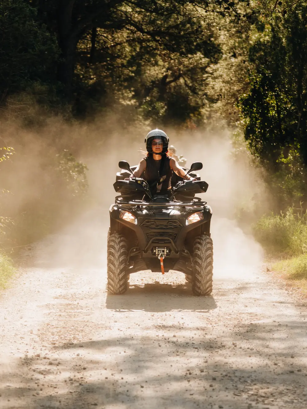 driving atv quad through dusty road